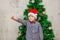 Portrait of a boy with funny glasses and christmas toys decorating cristmas tree and have fun