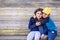 Portrait of boy and girl sitting in the street of suburb