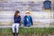 Portrait of boy and girl sitting in the street of suburb