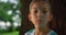 Portrait of boy holding ball near tree. Kid posing with soccerball in park.