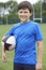 Portrait Of Boy Holding Ball On School Rugby Pitch