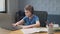 Portrait of boy learning online at home. Closeup child using laptop computer sitting at table in living room. School kid typing on