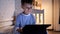 Portrait of boy in pajamas watching online video on tablet computer in bedroom at night. Children education, development, kids