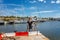 Portrait of a boy on the pier with moored sailing yachts