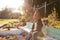 Portrait Of Boy Playing In Sand Box Outdoors In Garden