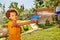 Portrait of a boy shoot water gun in fight game