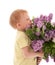 Portrait of boy smelling bouquet of lilac