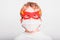 Portrait of boy in superhero mask with his mouth covered with a medical mask to protect himself from viral infections and diseases