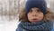 Portrait of boy of three years in winter outdoors.