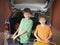 Portrait Of Boys Carrying Suitcases Against Car