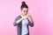 Portrait of brave teenage girl standing in defensive posture with raised fists, ready to punch. studio shot, pink background