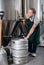 Portrait of brewer who is making beer and controls the process in the brew-house.