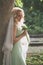 Portrait of bride with veil and bouquet of wild flowers outdoor