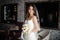 Portrait of bride in white wedding dress and bouquet with roses