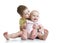 Portrait of brother kissing his little cute sister sitting on floor isolated on white background