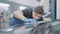 Portrait of brunette concentrated service man checking tuning of car hood in repair shop. Focused Caucasian employee