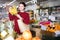 Portrait of brunette girl buying ripe bananas in supermarket