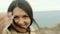 Portrait of a brunette girl looking at the camera on the background of the sea