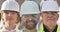 portrait of builders of different ages in a protective helmet looking at the camera while standing at a construction