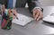 portrait of business man hand writing at notebook and holding mobilephone