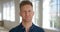 Portrait of a business man showing a serious facial expression while standing alone in an office. Closeup headshot and