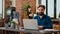 Portrait of business man working on laptop with charts and graphs