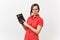 Portrait of business teacher or accountant woman in red shirt, glasses holding calculator in hands on white