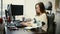 Portrait business woman at desk typing on computer