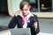 Portrait of business woman in glasses sitting in the city and looking at a laptop surprisingly