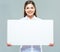 Portrait of business woman holding sign board.