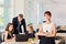 Portrait of business woman in the office in a chair on the background of working business partners.