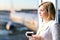 Portrait of business woman standing with coffee near window. Airport