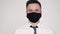 Portrait businessman manager in medical mask turns to camera. office worker sick ill with flu