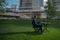 Portrait of businessman sitting on modern outdoor working place. Business man on terrace in modern business centre.