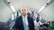 Portrait of a businessman in suit and blue tie on escalator in London underground, people passing b