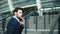 Portrait businessman walking upstairs near stadium. Man looking away outdoors