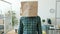 Portrait of businessman wearing paper bag with no emotions emoji standing in office