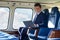 Portrait Of Businessman Working On Laptop In Helicopter Cabin Du