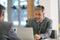 Portrait of businessmen working on laptop