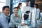 Portrait of businesspeople sitting at desk