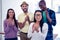 Portrait of businesswoman applauding with team