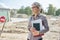 Portrait of businesswoman on construction site repairing road