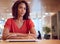 Portrait Of Businesswoman At Desk In Modern Office Work Space With Closed Laptop