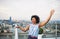 A portrait of businesswoman standing against London rooftop view panorama.