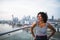 A portrait of businesswoman standing against London rooftop view panorama.