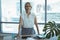 Portrait of businesswoman standing by desk