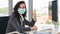 Portrait of businesswoman wearing medical mask during working in office to protect from coronavirus covid 19 infection,