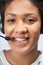 Portrait Of Businesswoman Wearing Telephone Headset In Customer Services Department