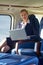 Portrait Of Businesswoman Working On Laptop In Helicopter Cabin
