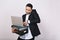 Portrait busy hard-working astonished businessman with office folders, laptop talking on phone on white background